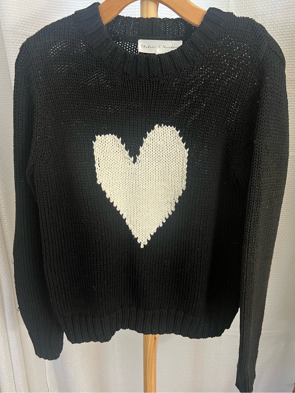 Chelsea & Theodore Black Crewneck Sweater with assymetrical White Heart